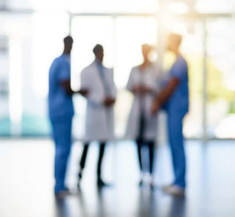 Blurred shot of a team of doctors standing together in a hospital