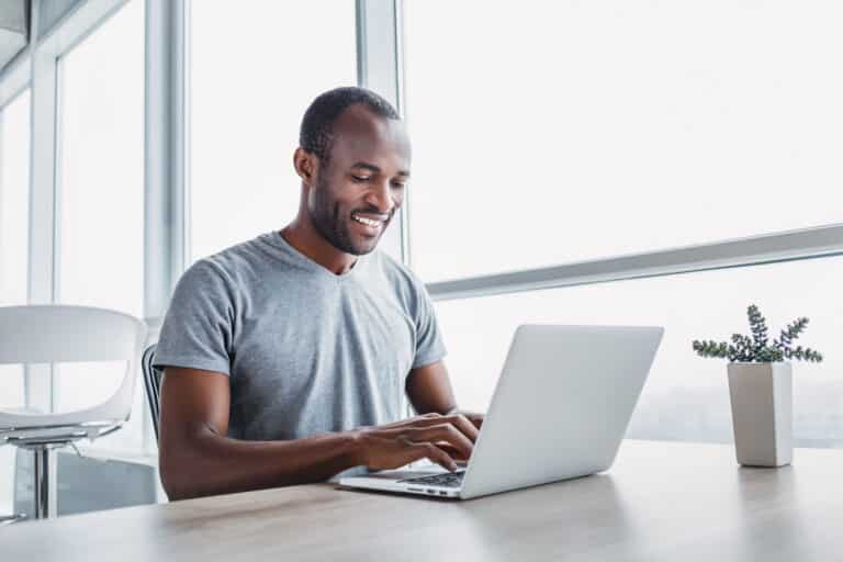 Young businessman working on his laptop in spacious bright office